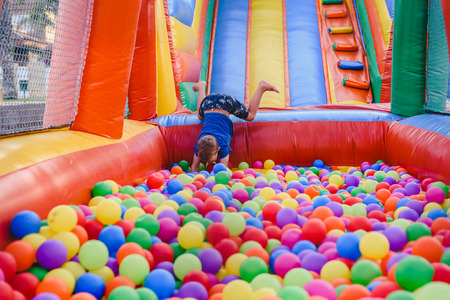 Inflatable castle full of colored balls for children to jump