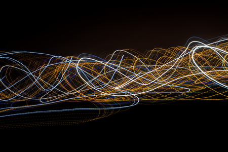Colorful light painting with circular shapes and abstract black background.の写真素材