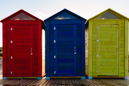 Cabins changers for bathers on a beach of the Mediterranean in summer, colored blue, yellow and red.の写真素材