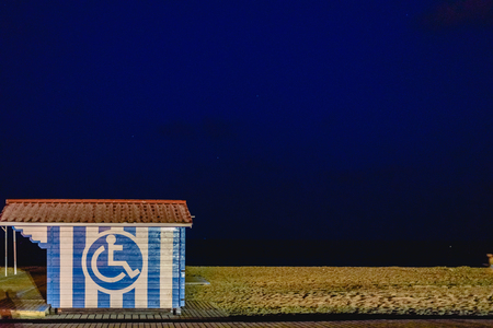 Box on the beach for disabled people with a symbol painted on itの写真素材