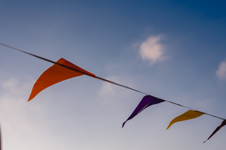 colorful garlands waving in the wind against a blue sky ideal for decorating a birthday.