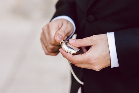 Old pocket watch in the hands of a manの写真素材