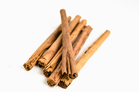 Stack of cinnamon sticks on white background and spaceの写真素材