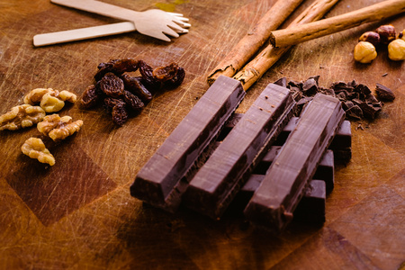 Plate of black chocolate chips with cinnamon and hazelnutsの写真素材