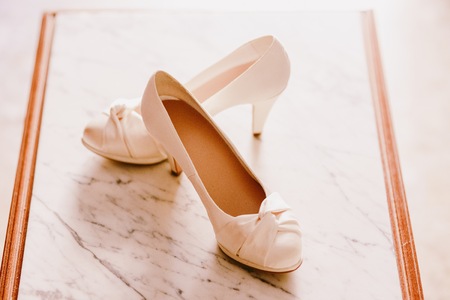Wedding shoes on their wedding isolated in a roomの写真素材