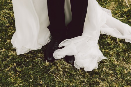 Detail of a white and elegant wedding dress.