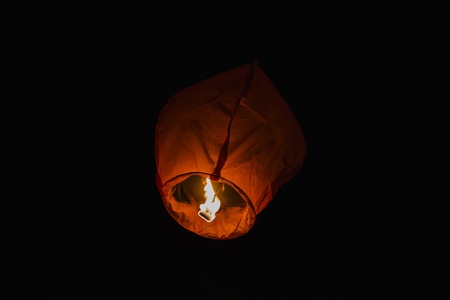 Thai lanterns thrown into the air at nightの写真素材