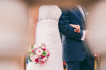 Wedding couple at their wedding strolling.の写真素材