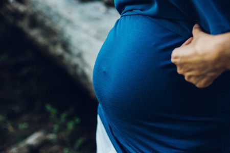Pictures of the belly of pregnant women in nature with natural background
