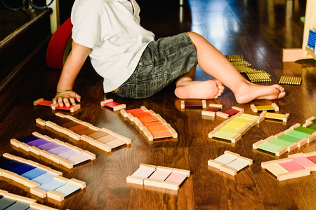 Children playing and learning with montessori color tablets