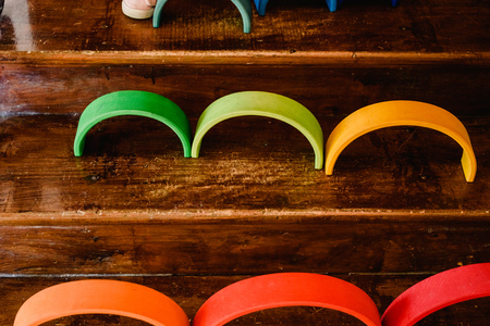 Little girl playing with waldorf montessori rainbow of various colorsの写真素材