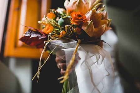 Bridal bouquet held by her with her hands at her weddingの写真素材