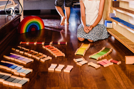 Children playing with wooden rainbow waldorf montessoriの写真素材