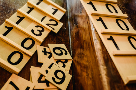 Wooden numbers in tables to learn mathematics in a Montessori classroom.