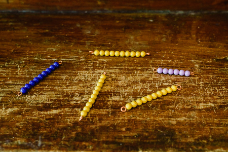 Beams to learn to count in a montessori classroom on aged wood.の写真素材