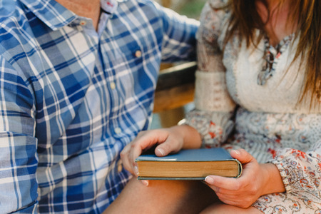 Couple reading books in a parkの写真素材