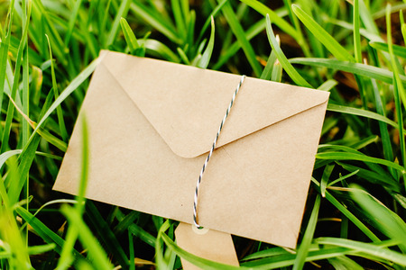 Old envelope on the lawn with room to place textの写真素材