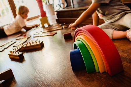 Children playing with wooden rainbow waldorf montessoriの写真素材