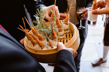Tasty wedding appetizers served by waiters to the guestsの写真素材
