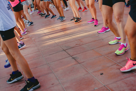 Fitness class and popular outdoor aerobics with monitor on a beach in summer