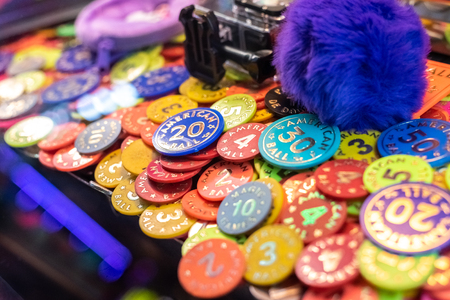Colorful poker chips in casino machine to win prizesの写真素材