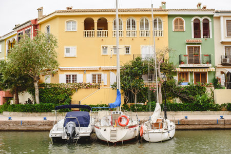 Valencia, Spain - September 30, 2018: Boats moored at the embankment next to Venetian style buildings in the residential port of Port SaPlaya.のeditorial素材