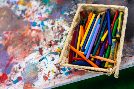 Box of paintings and children's markers.の写真素材