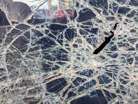 Car windshield shattered with stones by vandals.