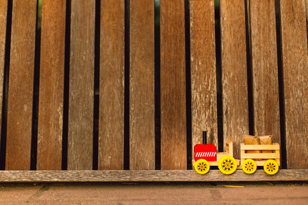 Toy wooden truck transporting packages on a background of woods, copy space.の写真素材
