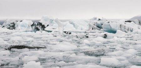 Large icebergs detached from the tongue of a glacier reaching the coast, in Iceland, paradise for adventurers.の写真素材