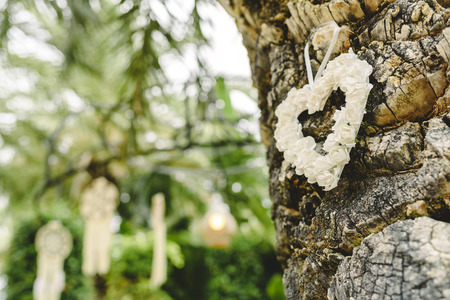Heart of flowers hanging from a tree as decorationの写真素材