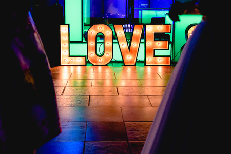 Bright wooden letters with word Love in a partyの写真素材