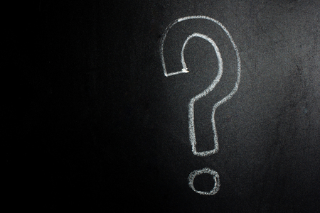 Question mark written by hand on a blackboard.の写真素材