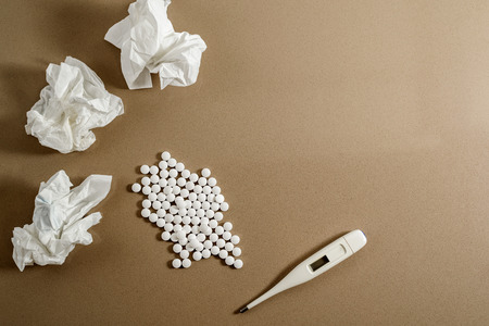 White pills to treat the common cold in winter, isolated on white background.
