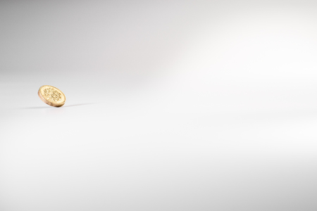 1 British pound coin falling on white background, isolatedの写真素材