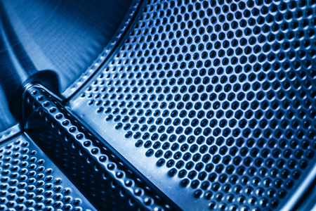 Detail of the drum of a washing machine, steel industrial texture with holes.の写真素材