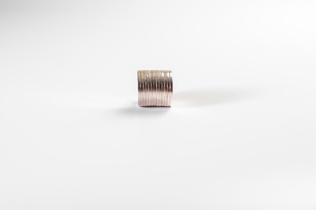 Stack of silver coins isolated on white background, industryの写真素材