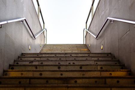 Granite staircase with handrails at the entrance of an underground pedestrian tunnel.の写真素材
