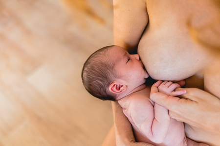 Newborn baby sucking breastfeeding from his mother's breast.の写真素材