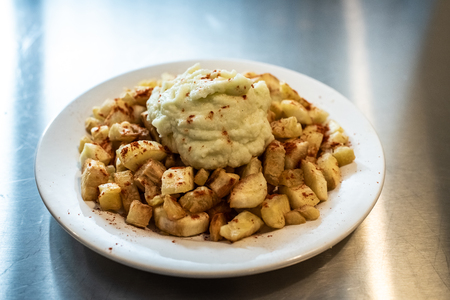 Yuca fried with hummus sauce.