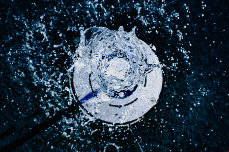 Water jet going up towards the camera, blue tones, background for hydrological concept.の写真素材