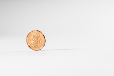 Dollar coin rotating on white background, concept of American economy.の写真素材