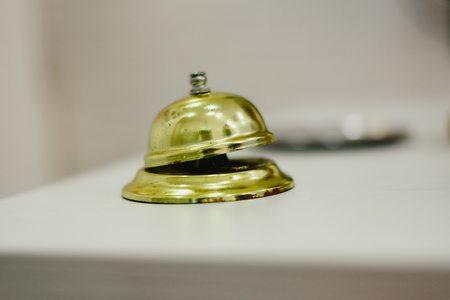 Old bell to call the bellman in a hotel, Service bell hotel golden.
