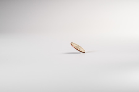 Dollar coin rotating on white background, concept of American economy.