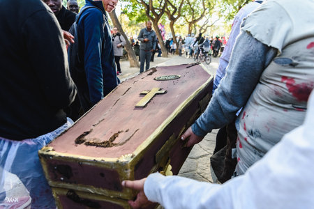 Valencia, Spain - February 16, 2019: False coffin transported by actors disguised in a street carnival.のeditorial素材