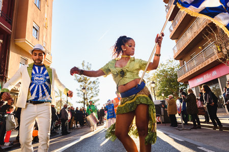 Valencia, Spain - February 16, 2019: Brazilian woman with a flag dancing samba during a carnival...