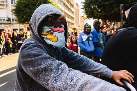 Valencia, Spain - February 16, 2019: Young man with hood and face covered by the streets of a city...