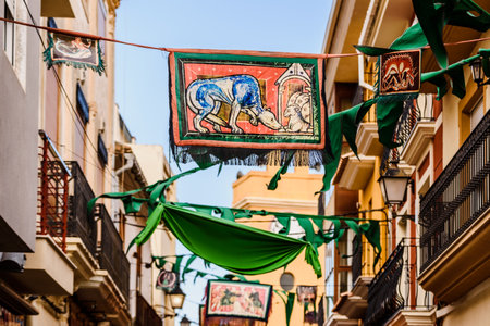 Valencia, Spain - January 27, 2019: Medieval banners hanging between streets at an open-air festival.のeditorial素材