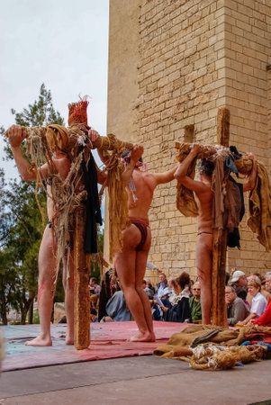 Valencia, Spain - April 9, 2009: Actor during the representation of the crucifixion of Jesus Christ at Easter while hanging from the cross.のeditorial素材