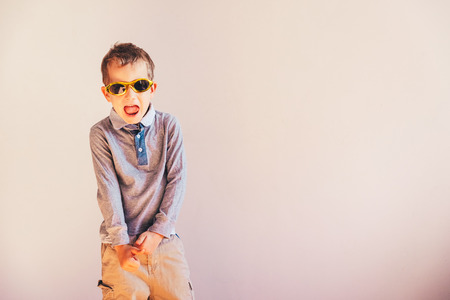 Child having fun gesturing and dancing, on white background and copy space.の写真素材